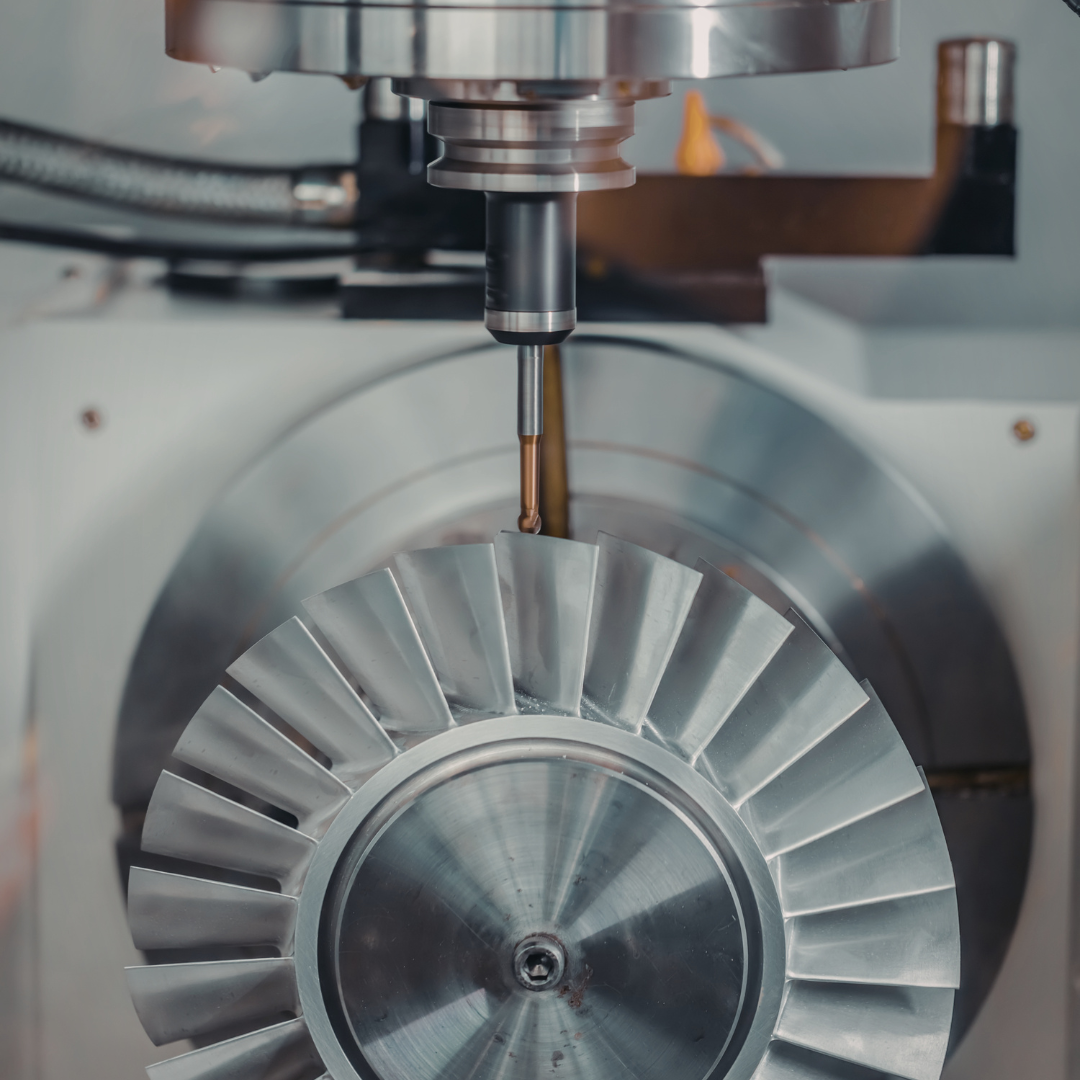 Two engineers (or client + engineer) discussing drawings or CAD renders on a tablet or laptop.